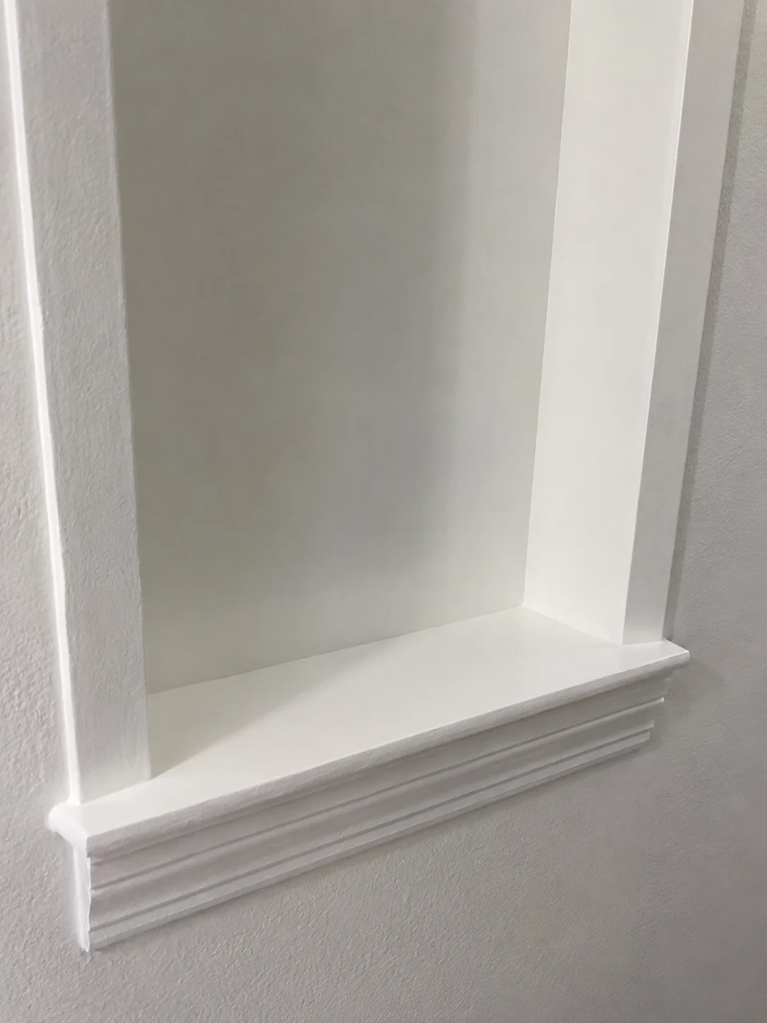 Clean white baseboards and window sill after a detailed deep cleaning by ISA Cleaning Services in Nassau County, Long Island