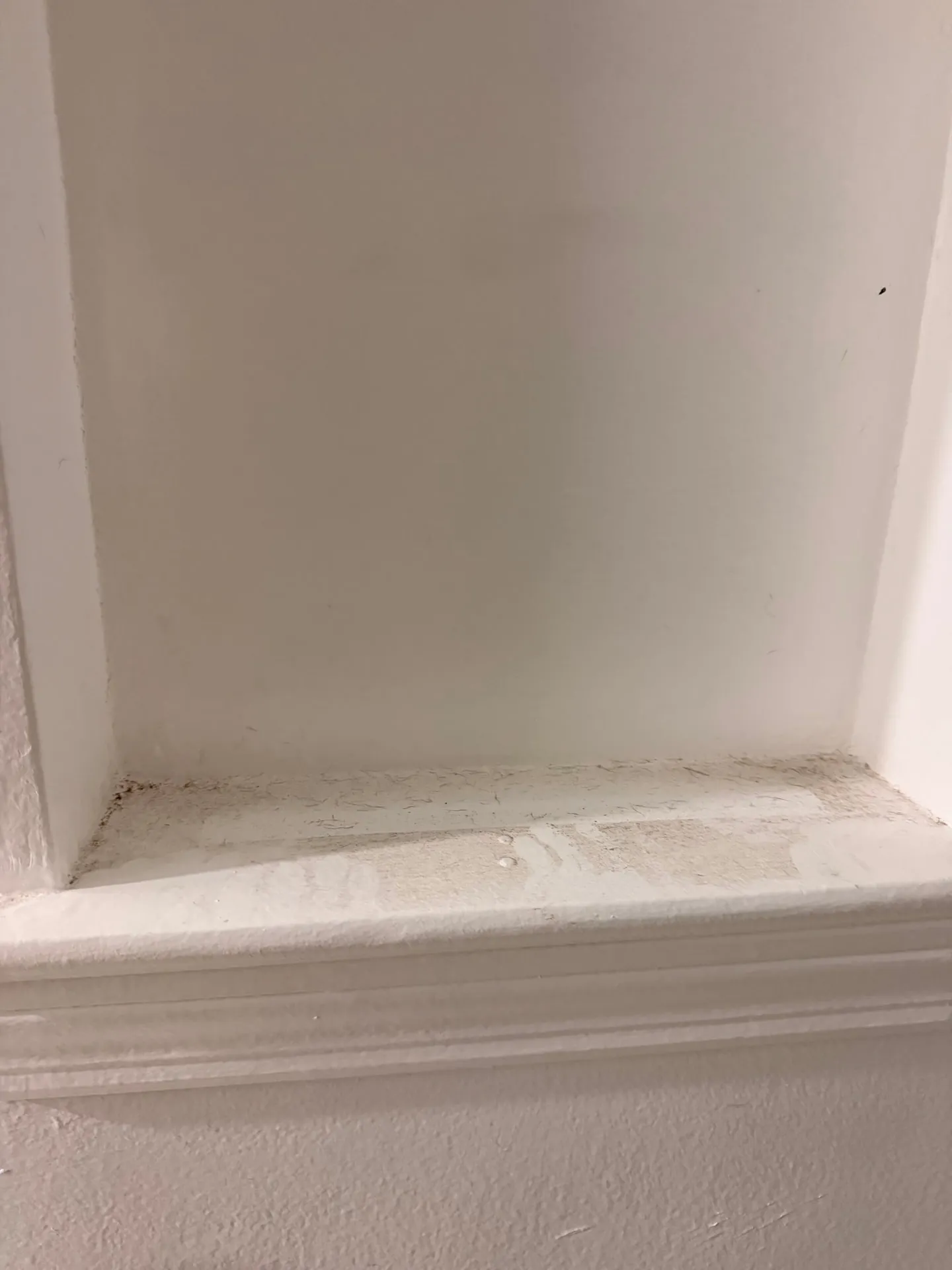 Dusty baseboards and window sill buildup before a detailed deep cleaning by ISA Cleaning Services on Long Island