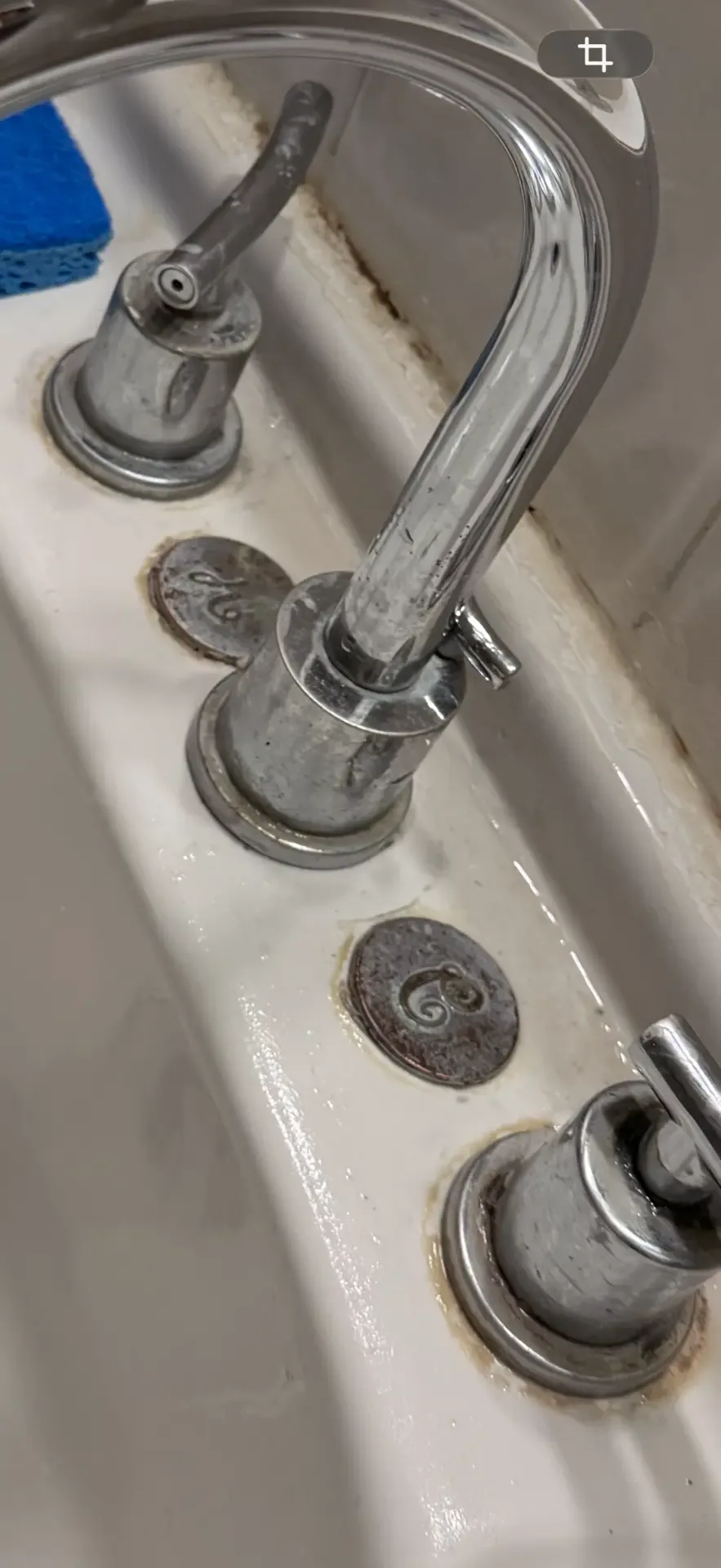 Bathroom sink faucet and handles covered in grime and hard-water buildup before deep cleaning by ISA Cleaning Services on Long Island