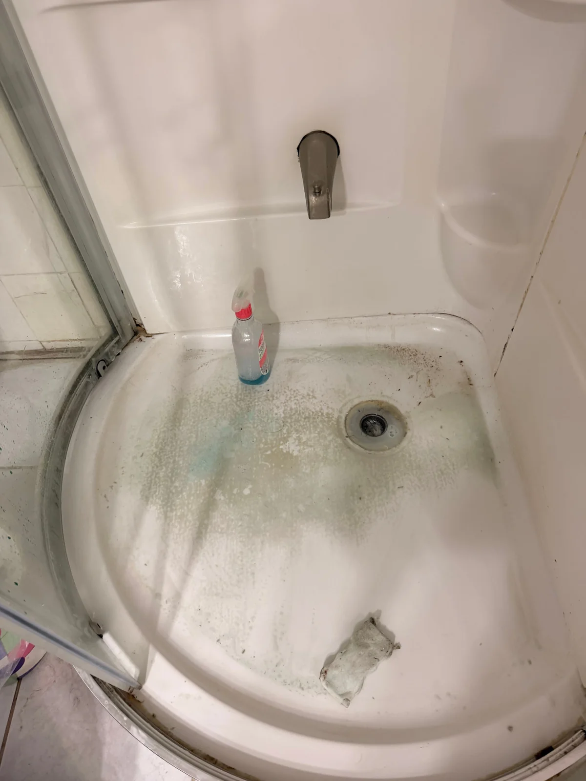 Dirty shower stall with soap scum and grime buildup before a deep cleaning by ISA Cleaning Services on Long Island