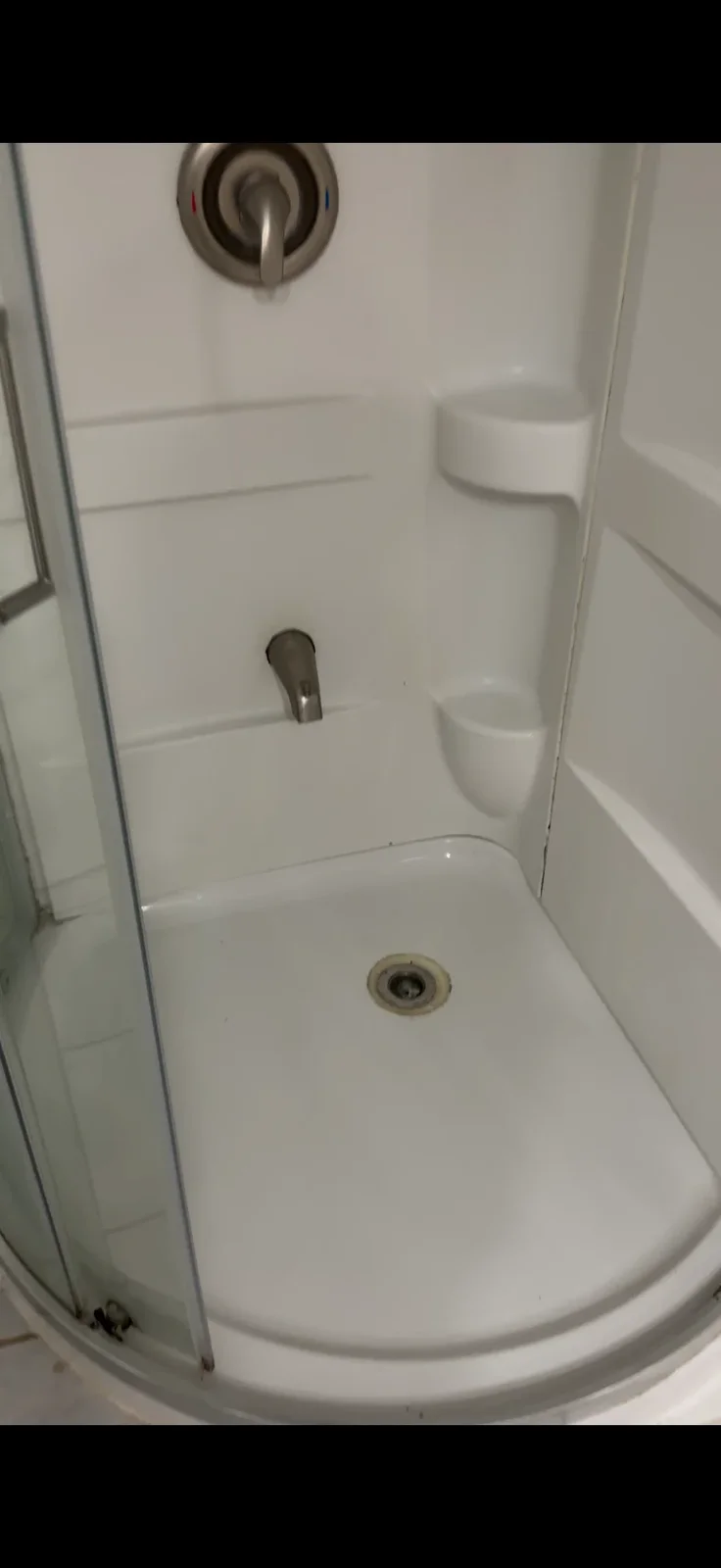 Sparkling clean white shower stall after a professional deep cleaning by ISA Cleaning Services in Nassau County, Long Island